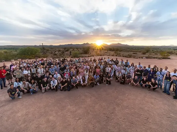 The Tilt Team gathered for an all-company photo at sunset during a global company onsite.